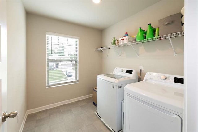 laundry room featuring independent washer and dryer, baseboards, and light flooring