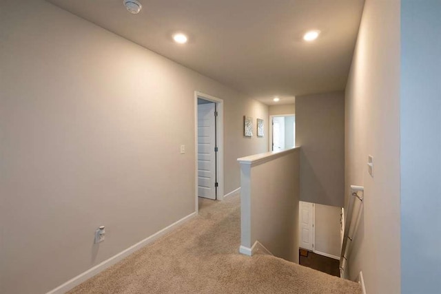 corridor with an upstairs landing, baseboards, carpet, and recessed lighting