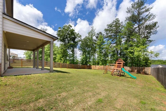 view of yard featuring a patio and a playground