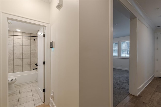 full bathroom featuring toilet, tiled shower / bath combo, and vanity