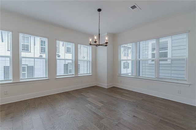 kitchen featuring hanging light fixtures, wood-type flooring, ornamental molding, and a notable chandelier