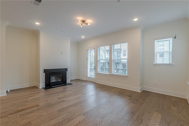 spare room with hardwood / wood-style flooring and crown molding