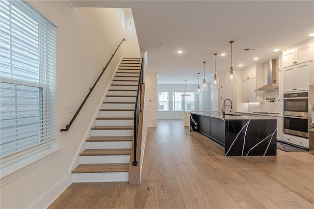 bathroom with vanity, a wealth of natural light, and hardwood / wood-style flooring