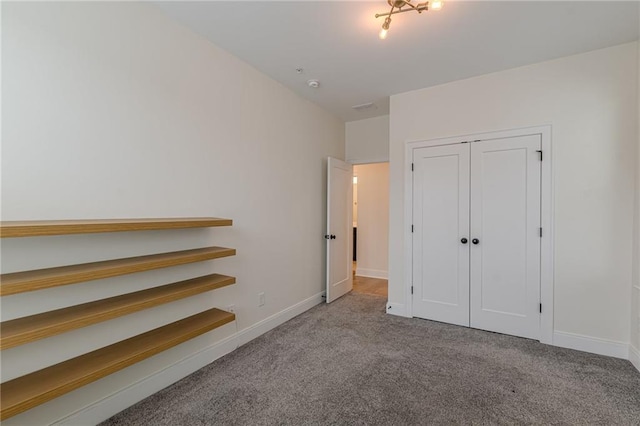 carpeted empty room featuring ceiling fan and a raised ceiling