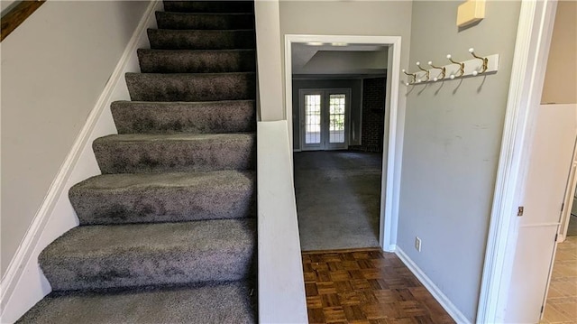 staircase with french doors and parquet flooring