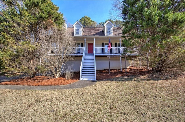 cape cod-style house with covered porch and a front yard