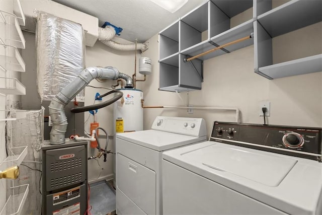 laundry area featuring washing machine and clothes dryer, laundry area, and water heater