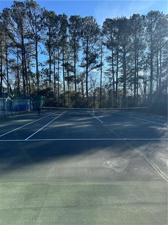 view of tennis court featuring fence