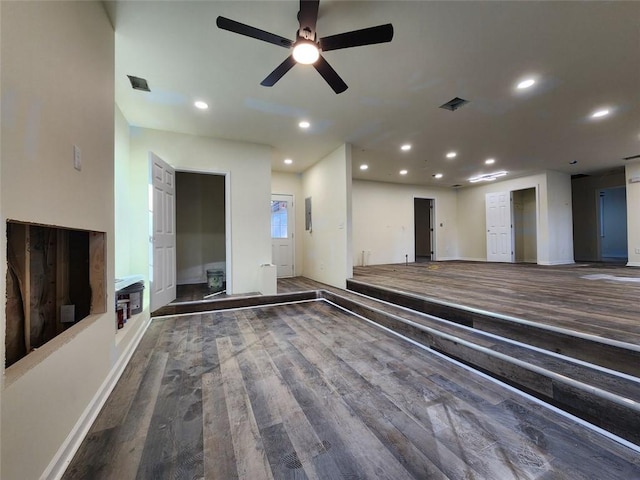 unfurnished living room featuring ceiling fan and hardwood / wood-style floors