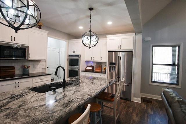 223 Deans Dr, Dawsonville, GA 30534 - kitchen featuring a sink, tasteful backsplash, a breakfast bar, dark wood finished floors, and stainless steel appliances