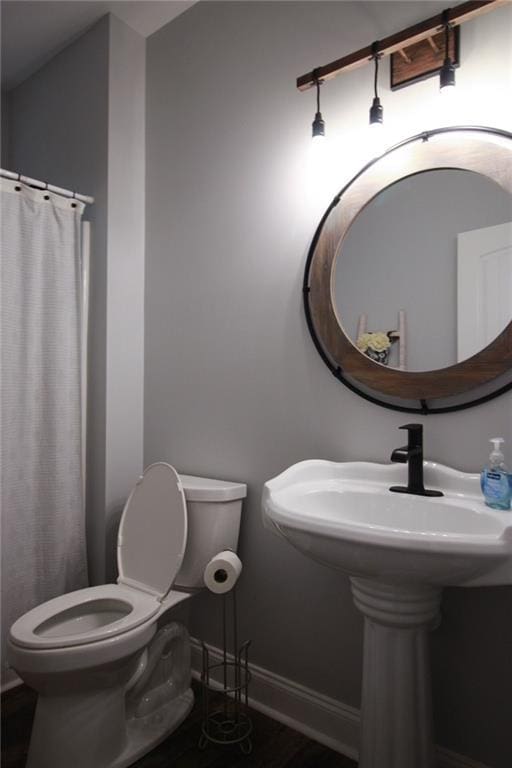 223 Deans Dr, Dawsonville, GA 30534 - bathroom with baseboards, toilet, and curtained shower