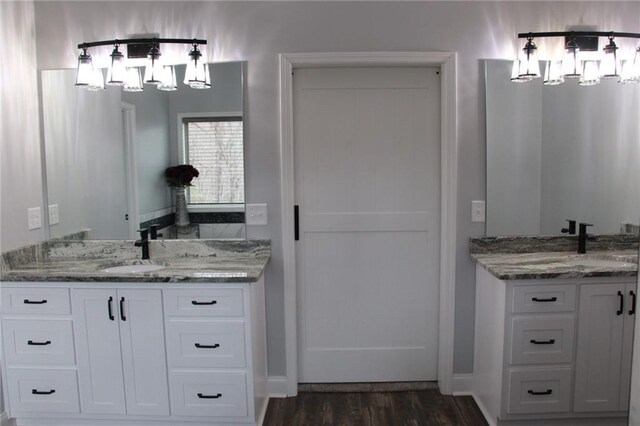 223 Deans Dr, Dawsonville, GA 30534 - bathroom with wood finished floors, a chandelier, and two vanities