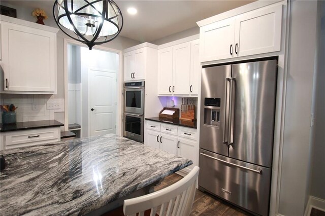 223 Deans Dr, Dawsonville, GA 30534 - kitchen featuring white cabinetry, backsplash, and appliances with stainless steel finishes