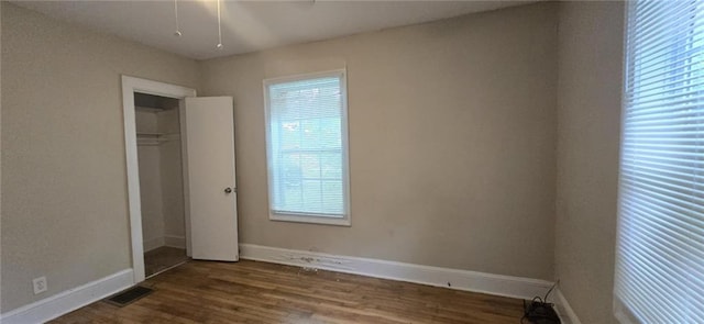 1516 Carter Rd, Decatur, GA 30032 - unfurnished bedroom with baseboards, visible vents, and wood finished floors