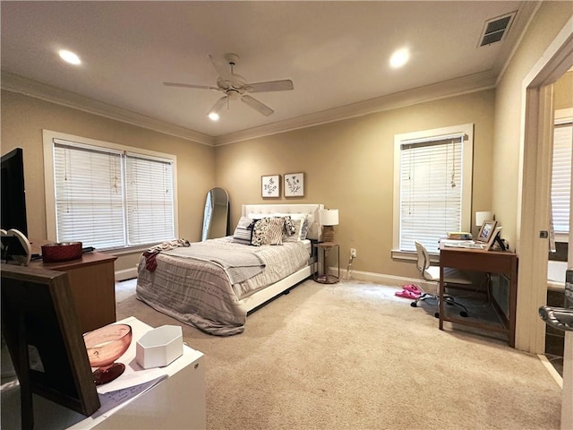 carpeted bedroom featuring ornamental molding and ceiling fan