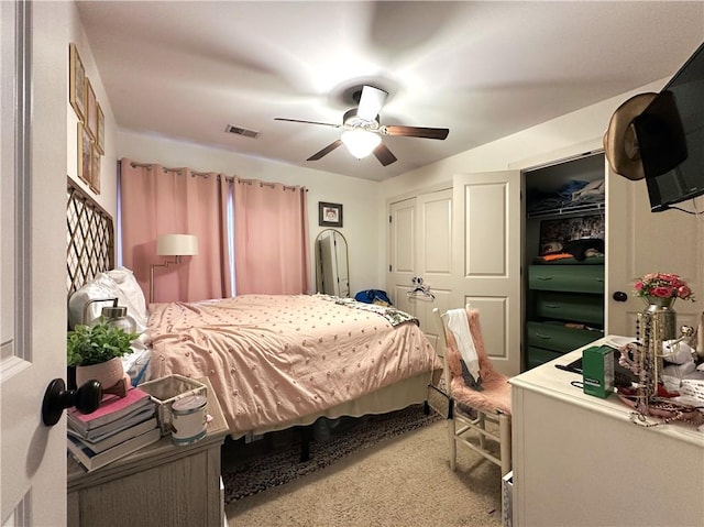 bedroom featuring a closet, ceiling fan, and light colored carpet