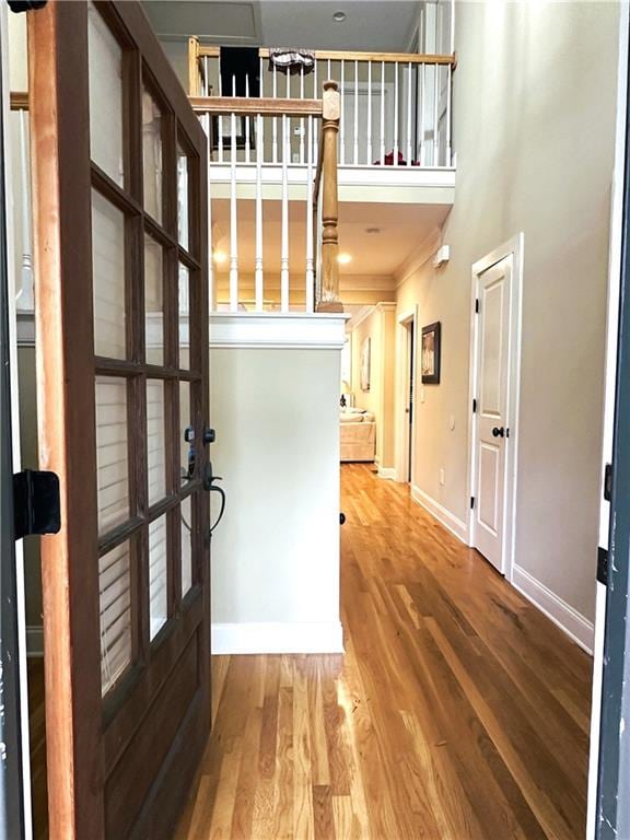 interior space featuring hardwood / wood-style flooring, crown molding, and french doors