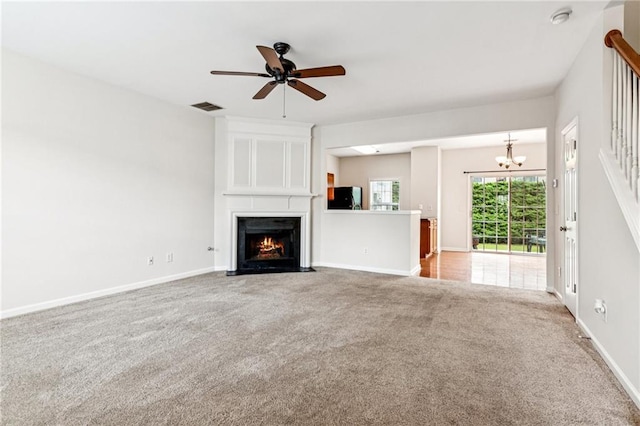 1049 Prestwyck Ct, Alpharetta, GA 30004 - unfurnished living room featuring carpet, a chandelier, a large fireplace, and a ceiling fan