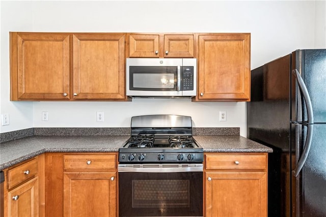 1049 Prestwyck Ct, Alpharetta, GA 30004 - kitchen featuring stainless steel appliances, dark countertops, and brown cabinets