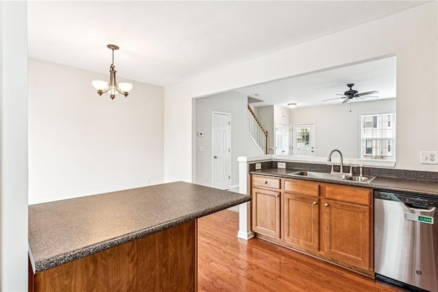 1049 Prestwyck Ct, Alpharetta, GA 30004 - kitchen with dishwasher, dark countertops, a peninsula, light wood finished floors, and brown cabinets