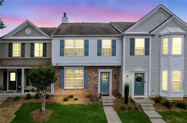 1049 Prestwyck Ct, Alpharetta, GA 30004 - townhome / multi-family property featuring brick siding, a chimney, and a front lawn