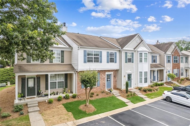 1049 Prestwyck Ct, Alpharetta, GA 30004 - multi unit property featuring a chimney, uncovered parking, brick siding, covered porch, and a residential view