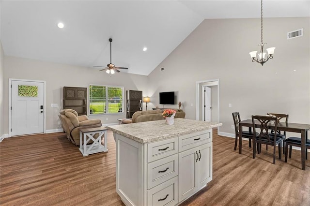 417 Beamer Rd SW, Calhoun, GA 30701 - kitchen featuring a chandelier, ceiling fan, high vaulted ceiling, wood finished floors, and white cabinets