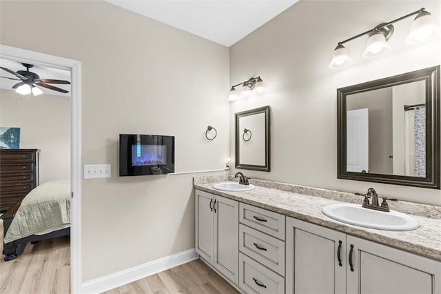 417 Beamer Rd SW, Calhoun, GA 30701 - ensuite bathroom with wood finished floors, double vanity, baseboards, and ceiling fan