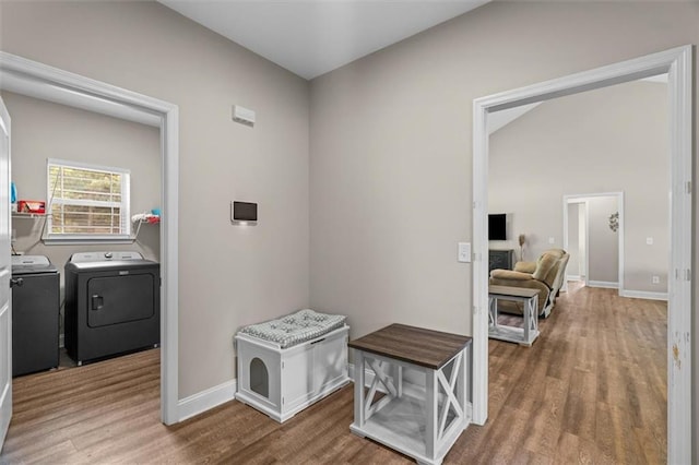 417 Beamer Rd SW, Calhoun, GA 30701 - corridor featuring washing machine and clothes dryer, wood finished floors, baseboards, and lofted ceiling