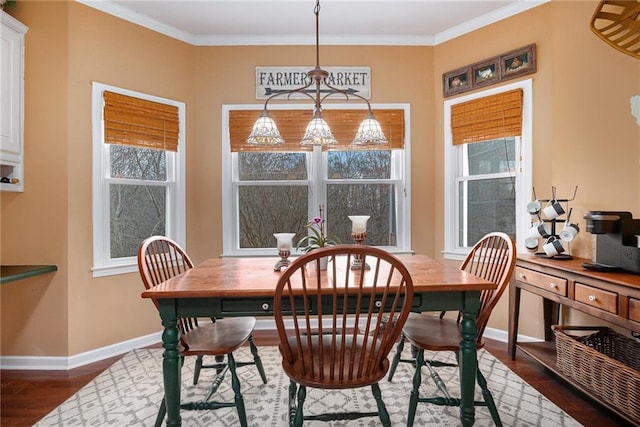 dining area featuring crown molding, dark wood-style floors, and baseboards