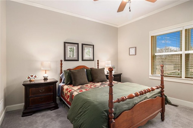 carpeted bedroom featuring a ceiling fan, crown molding, and baseboards