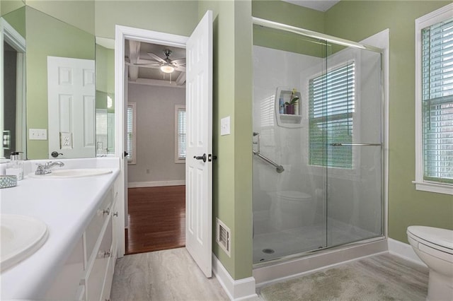 full bath with visible vents, toilet, a sink, wood finished floors, and a shower stall