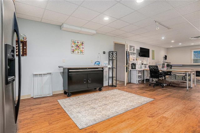 office space with visible vents, baseboards, recessed lighting, wood finished floors, and a paneled ceiling