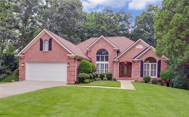2121 Brittany Ct, Gainesville, GA 30506 - view of front of house featuring brick siding, concrete driveway, a garage, a front lawn, and view of scattered trees