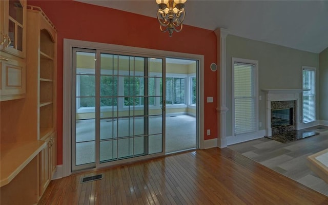 2121 Brittany Ct, Gainesville, GA 30506 - doorway featuring wood-type flooring, a chandelier, baseboards, and healthy amount of natural light