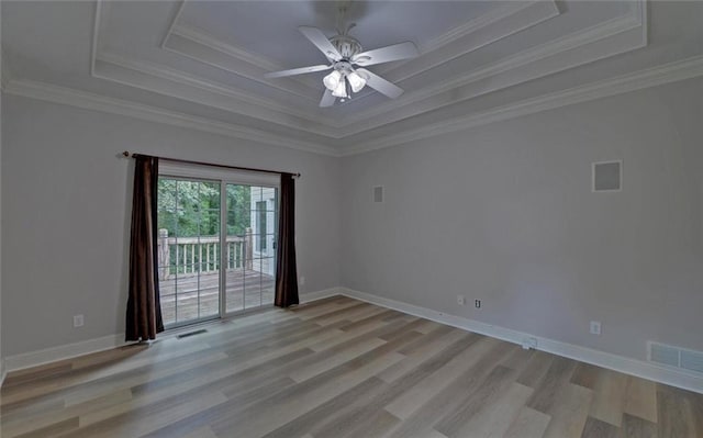 2121 Brittany Ct, Gainesville, GA 30506 - unfurnished room featuring a raised ceiling, light wood finished floors, a ceiling fan, ornamental molding, and baseboards