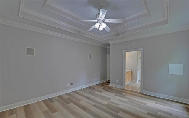 2121 Brittany Ct, Gainesville, GA 30506 - spare room featuring a tray ceiling, light wood-style floors, a ceiling fan, crown molding, and baseboards
