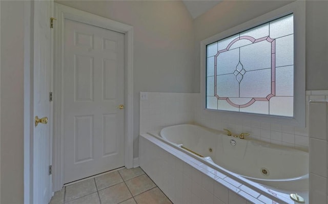2121 Brittany Ct, Gainesville, GA 30506 - bathroom with a tub with jets, tile patterned flooring, and vaulted ceiling