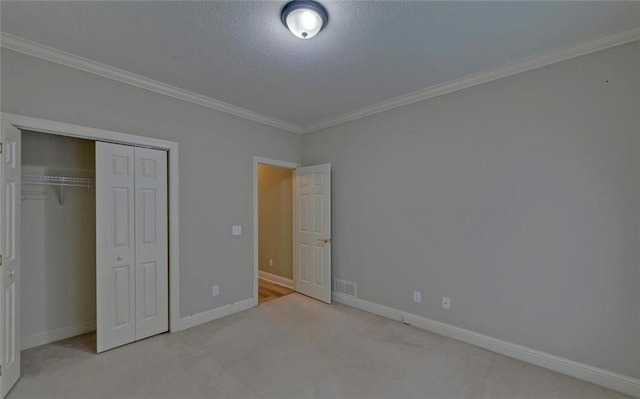 2121 Brittany Ct, Gainesville, GA 30506 - unfurnished bedroom featuring crown molding, carpet floors, baseboards, a closet, and a textured ceiling