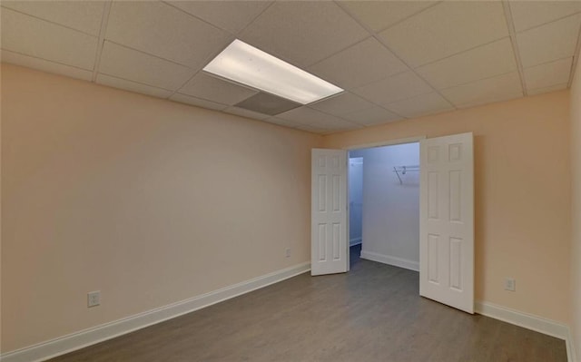 2121 Brittany Ct, Gainesville, GA 30506 - unfurnished bedroom featuring dark wood-type flooring, a paneled ceiling, and baseboards