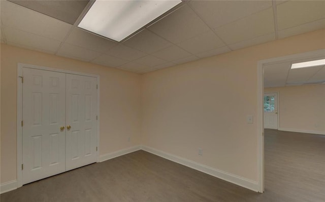 2121 Brittany Ct, Gainesville, GA 30506 - unfurnished bedroom with dark wood-style flooring, a drop ceiling, baseboards, and a closet