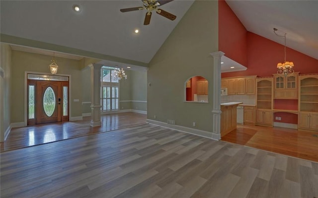 2121 Brittany Ct, Gainesville, GA 30506 - unfurnished living room with high vaulted ceiling, ceiling fan, light wood-style floors, a chandelier, and baseboards