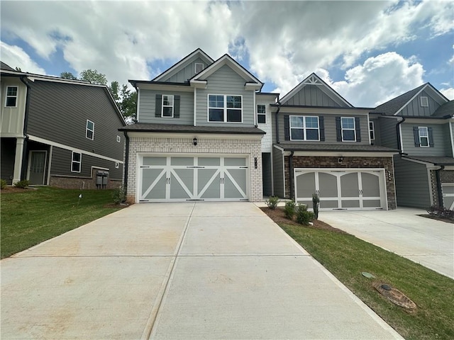 craftsman house featuring board and batten siding, an attached garage, driveway, and a front yard