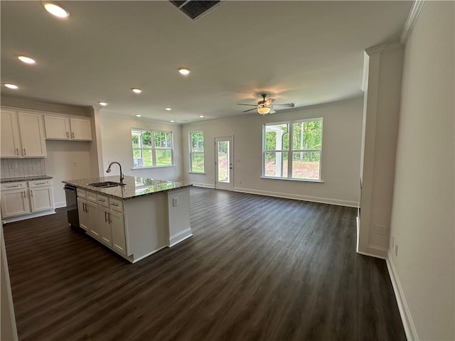 kitchen featuring visible vents, a ceiling fan, a sink, and dark wood-type flooring