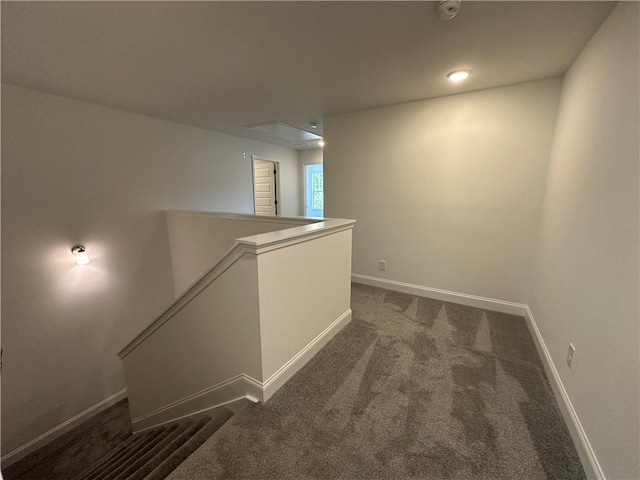 below grade area with baseboards and dark carpet