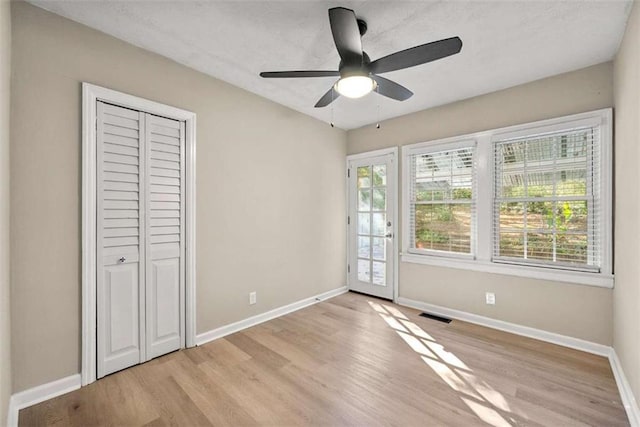 interior space with ceiling fan, a closet, and light hardwood / wood-style flooring