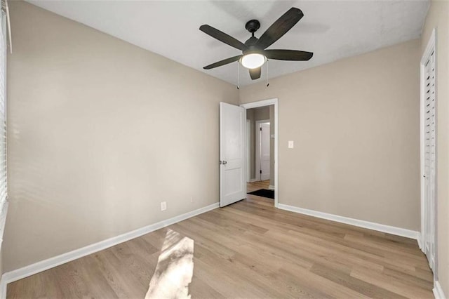 unfurnished bedroom with ceiling fan and light hardwood / wood-style flooring