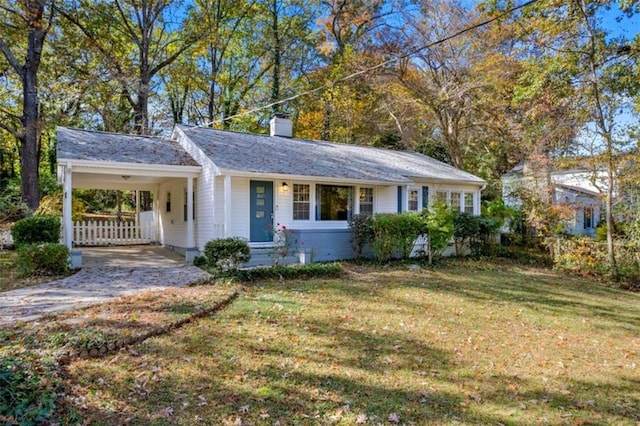 ranch-style home with a carport and a front lawn