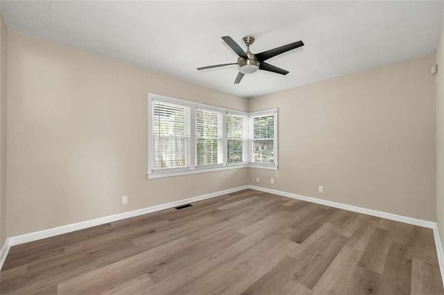 spare room with light hardwood / wood-style floors and ceiling fan