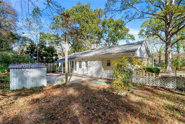 rear view of house featuring a shed and a patio